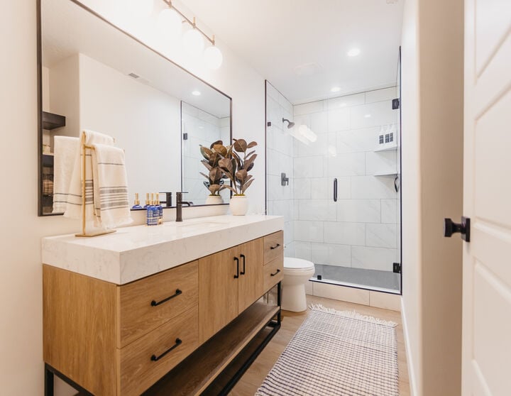 custom bathroom with wood cabinets and white counter in custom home by 10X Builders in Utah County, Utah