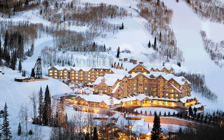 deer valley ski resort lit up ad night in snowy winter in utah - photo by Montage Hotels