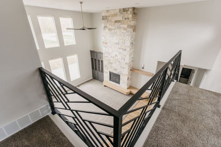 upstairs loft with black railing in custom home in Utah County by 10X Builders