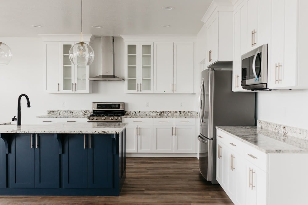 transitional light and airy kitchen with blue cabinets by 10x builders in Orem, UT