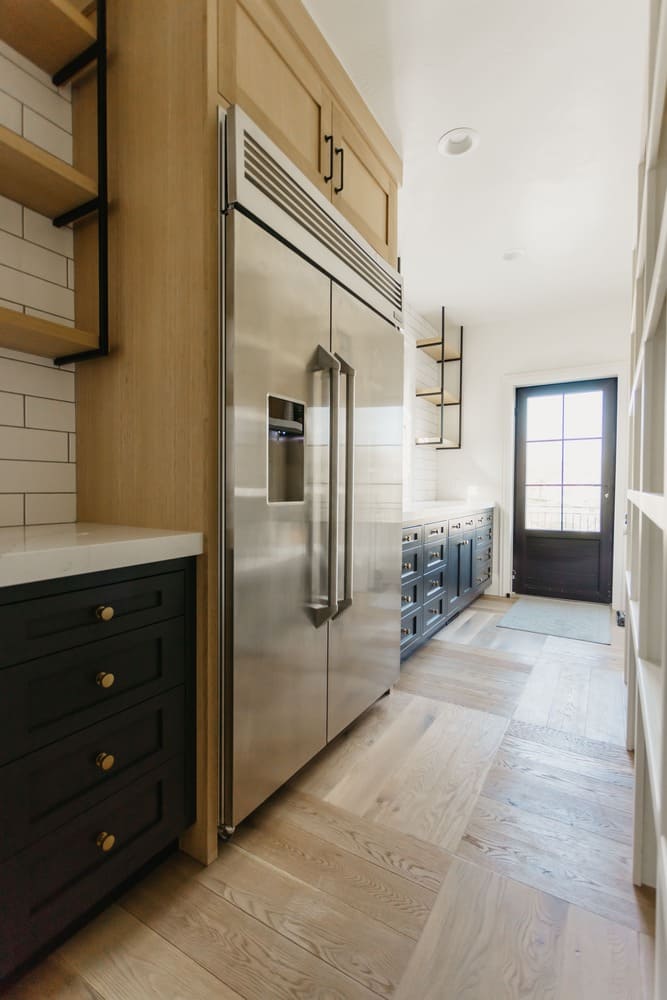 kitchen fridge with dark cabinets by 10x builders in utah county