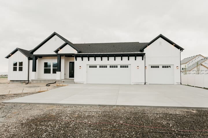 exterior of custom home with black roof in Utah County by 10X Builders