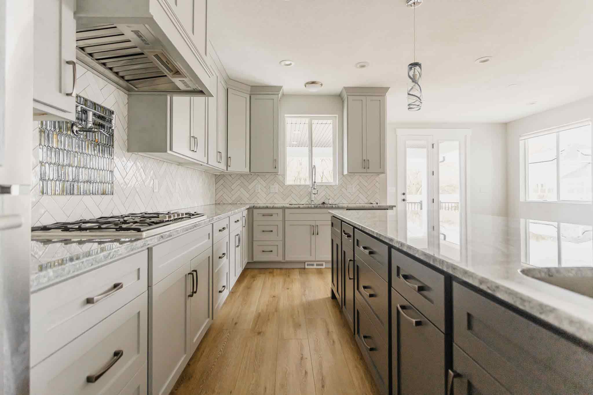 kitchen with cream & gray cabinets with light flooring by 10x builders in utah county
