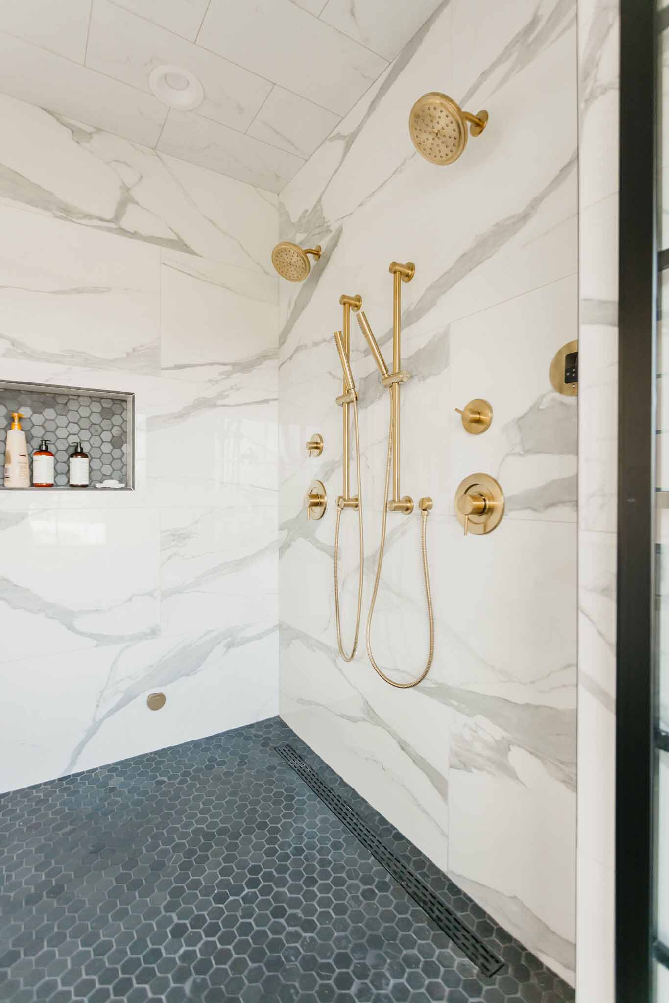 marble shower with gold hardware by 10x builders in utah county