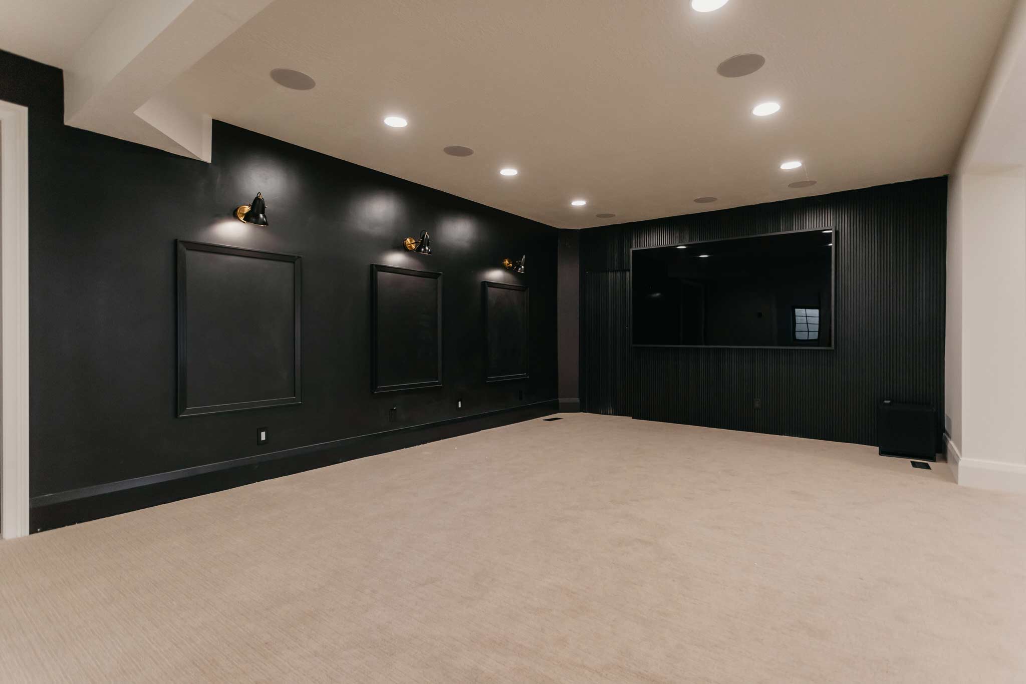 entertainment room with moody black walls by 10x builders in utah county