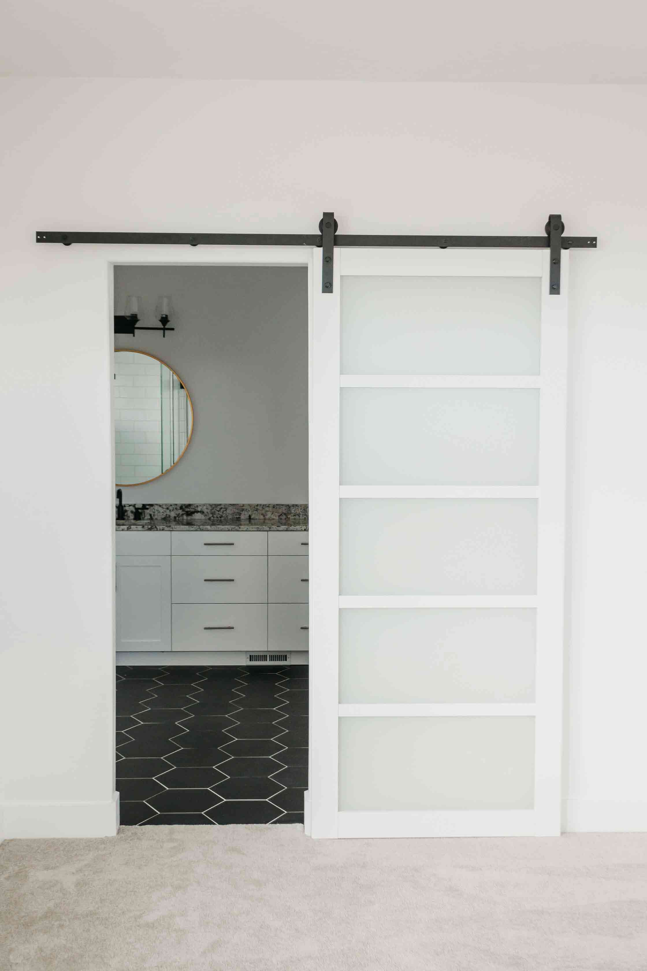 white bathroom barn door by 10x builders in utah county