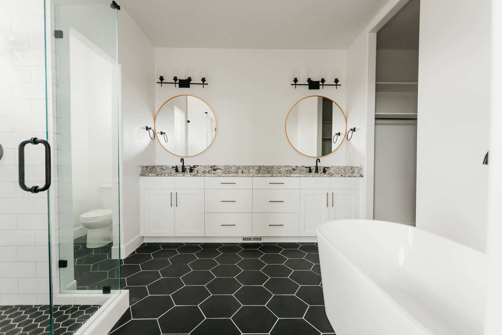 double bathroom vanity with black & white tile by 10x builders in utah county