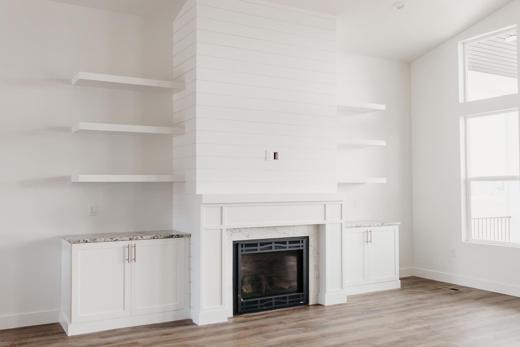 white fireplace with floating shelves by 10x builders in utah county